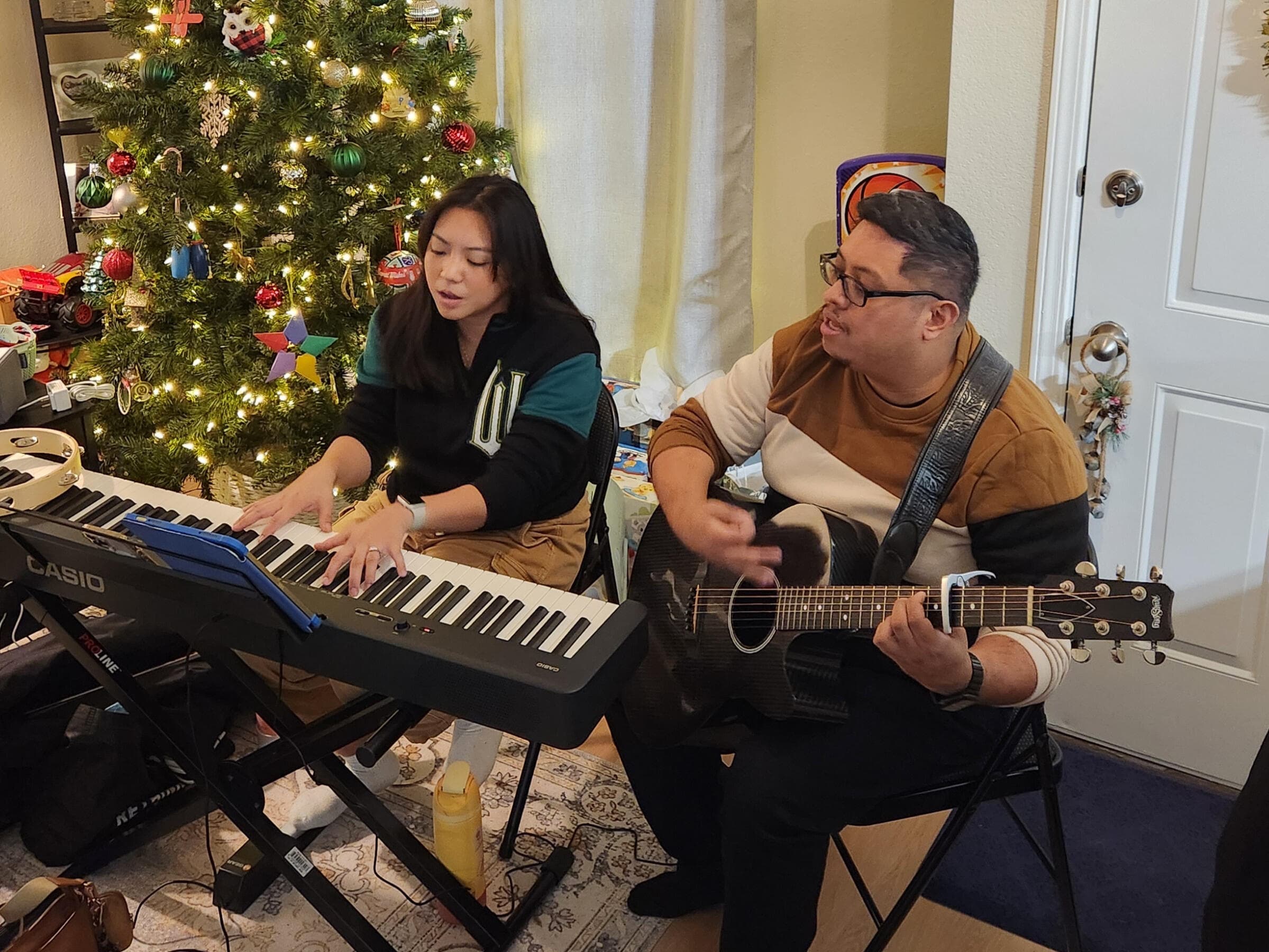 Playing a duet at home alongside an acoustic guitarist
